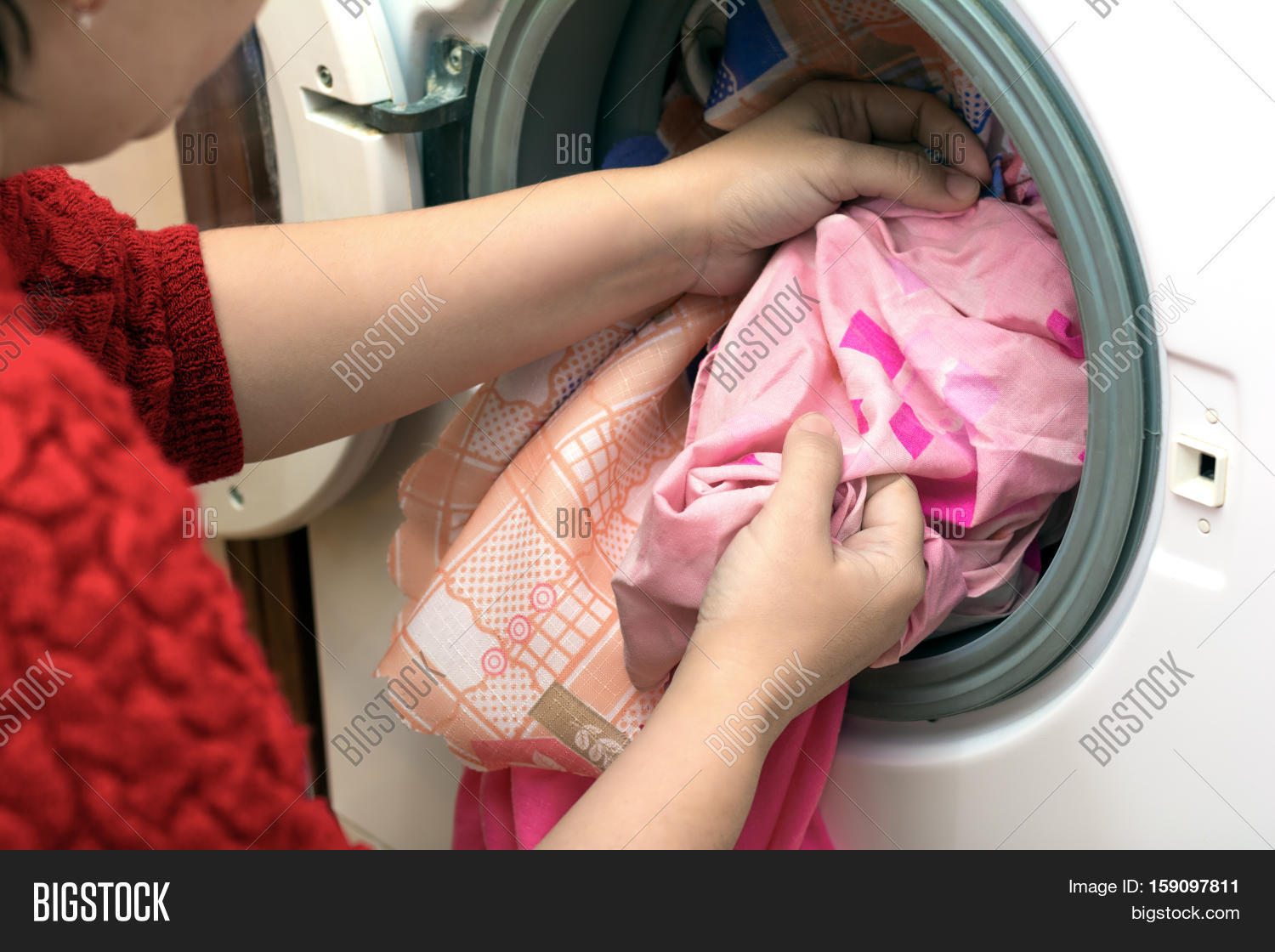 washing clothes in a washing machine at home