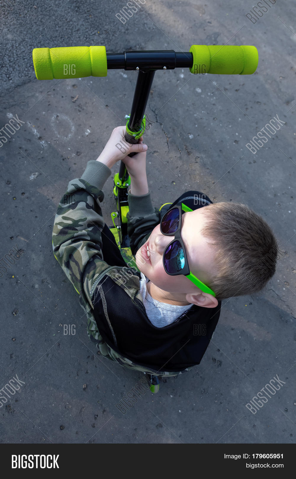 scooter boy photographed top view, sun glasses, blond hair